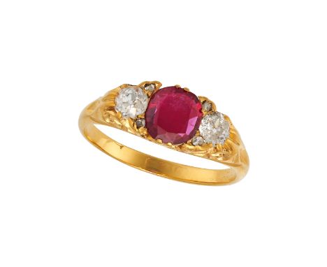 A RUBY AND DIAMOND THREE STONE RING in 18ct yellow gold, set with a cushion cut ruby of approximately 1.25 carats, accented o