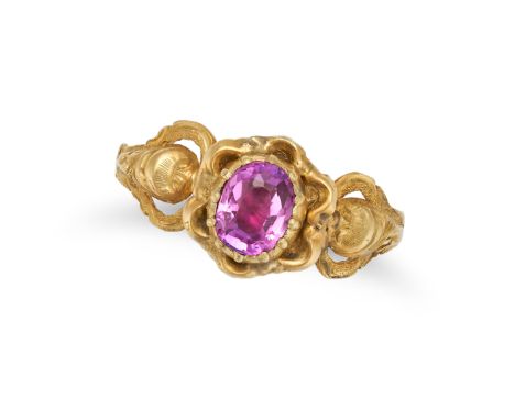 AN ANTIQUE PINK SAPPHIRE RING in yellow gold, the ornate band set with an oval cut pink sapphire, no assay marks, size L / 5.