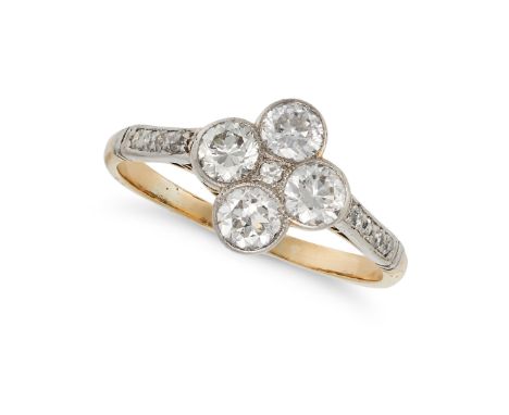 A DIAMOND DRESS RING in yellow gold and platinum, set with a single cut diamond in a cluster of four transitional cut diamond