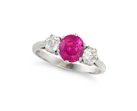 A THREE STONE RUBY AND DIAMOND RING in 18ct white gold, set with an oval cut ruby of approximately 1.59 carats, accented on e