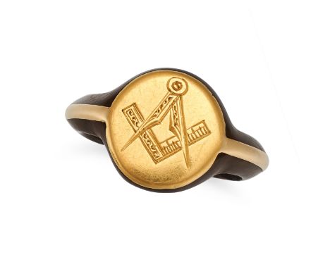 A MASONIC RING in yellow gold, the circular face engraved with masonic symbols, on a wooden band, no assay marks, size N1/2 /