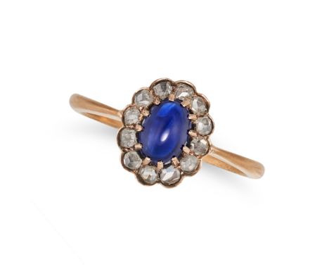 A SAPPHIRE AND DIAMOND CLUSTER RING in rose gold, set with an oval cabochon sapphire in a cluster of rose cut diamonds, no as