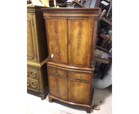 A Georgian style cabinet, the top with two doors with two graduated shelves to interior, above a brush slide, two short drawe