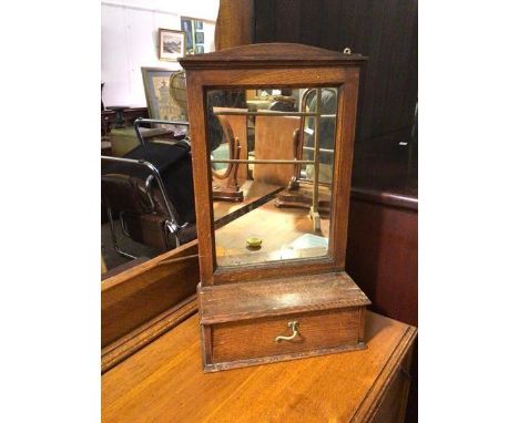 A 1920s/30s hanging mirror and shelf, the rectangular glass in oak frame above a shelf with single drawer (56cm x 32cm x 13cm