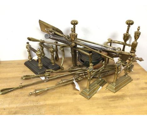 A quantity of brassware including four sets of andirons, various fire tools, a Vono knife cleaner (19cm x 19cm)