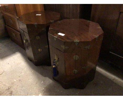 A pair of Chinese octagonal lamp tables, each with two hinged doors to side, opening to recess, on shaped bracket feet (50cm 