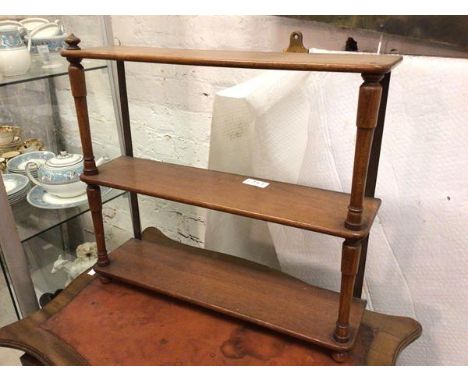 A late 19thc/early 20thc mahogany wall shelf with three tiers, on turned supports (57cm x 62cm x 15cm)