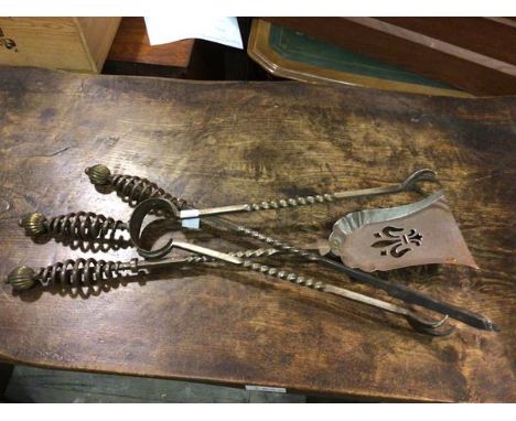 A set of fire tools including tongs, poker and shovel, all with a coiled handle with brass pommel (poker: 63cm)