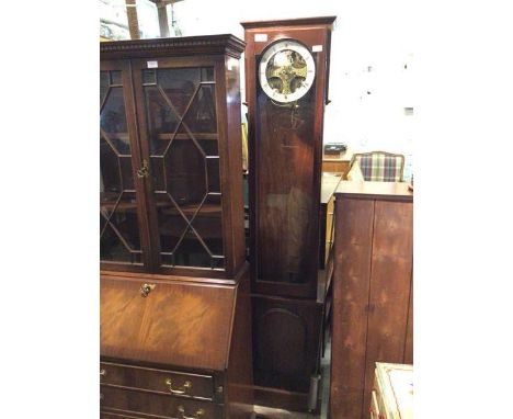 A latter half of the 20thc. longcase clock with the glass fronted door and circular dial with roman numerals, inscribed JAS. 