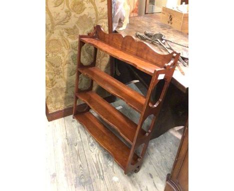 A modern wall shelf, with moulded ledge back above four shelves, with pierced supports (90cm x 69cm x 17cm)