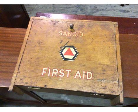A vintage First Aid cabinet, inscribed Sanoid, with fall front enclosing a fitted interior, on bracket feet (28cm x 33cm x 10