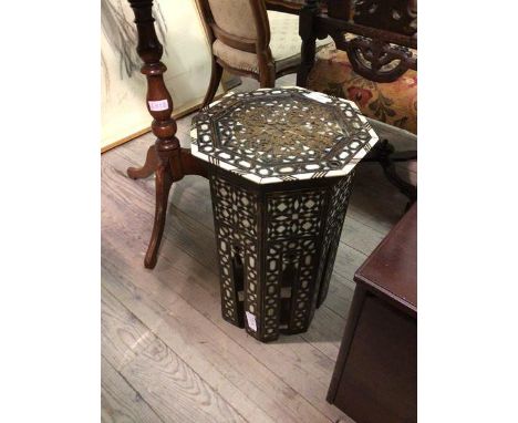 A Middle Eastern octagonal table, with mother of pearl and bone inlaid decoration (49cm x 36cm) (a/f)