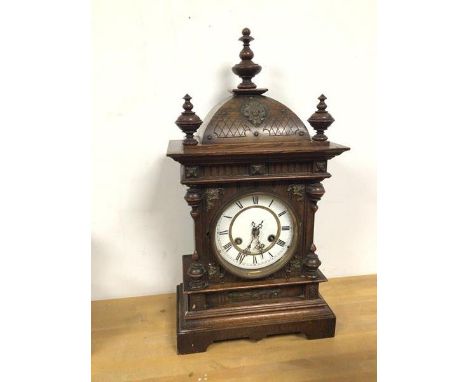 An early 20thc oak mantel clock of architectural form, with roman numerals (50cm x 28cm x 15cm)