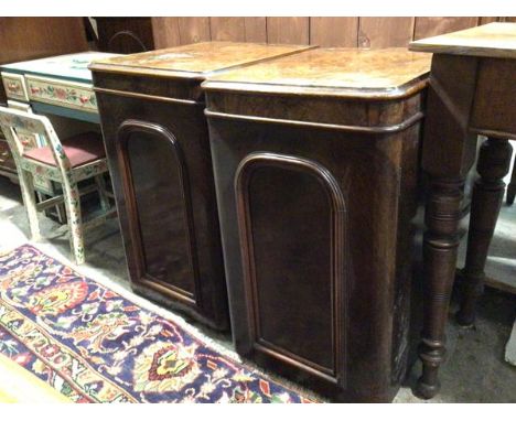 A pair of Victorian walnut veneered cabinets, possibly adapted from dressing table, both with panelled doors, one with shelf 