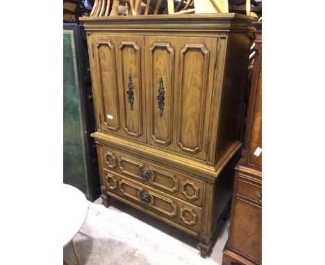 A modern linen cupboard, the rectangular moulded top above two panel doors with four sliding shelves to interior, above two d
