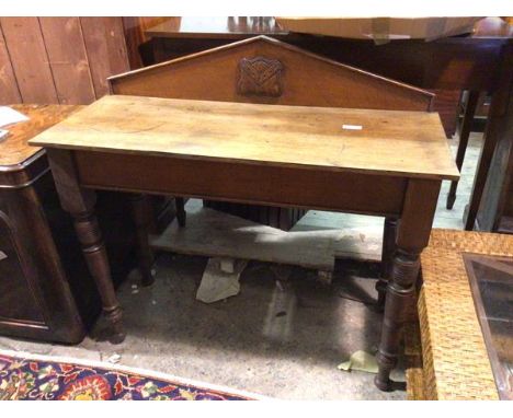 A 19thc oak side table, with pediment back with stylised heraldic panel above a rectangular top with plain frieze, on turned 