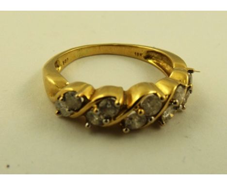 A 1980's/90's DIAMOND HALF HOOP RING having five pairs of brilliants diagonally set in a gold coloured metal setting stamped 