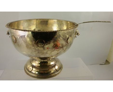 A MID 20TH CENTURY ELECTRO-PLATE ON COPPER PUNCH BOWL having gadroon rim, lion mask and coin inset belly, spot hammered, on c