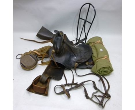 A VINTAGE LEATHER WESTERN SADDLE with original stirrups, water bottle and bedding roll, BRIDLE and a wall mounting SADDLE RAC