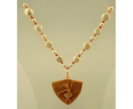 A PEACH JASPER CARVED PENDANT decorated with a ballerina, with coral, cultured pearls and mabe pearl necklace, 60cm long 
