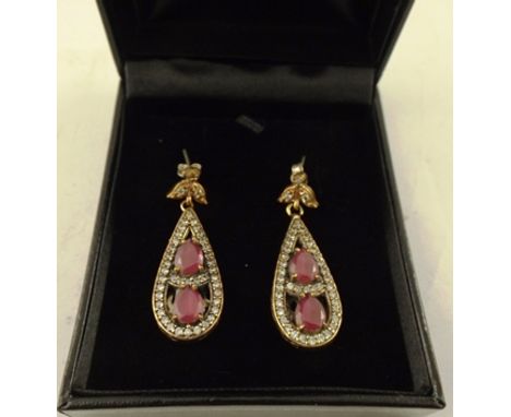 A PAIR OF GOLD FINISHED DROP EARRINGS, set with two ruby coloured stones and simulated diamonds around, on butterfly fitting 