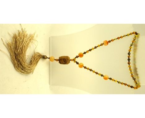 A JADE CARVED SAUTOIR BUDDHA HEAD with tassel, on bead chain, 80cm long 