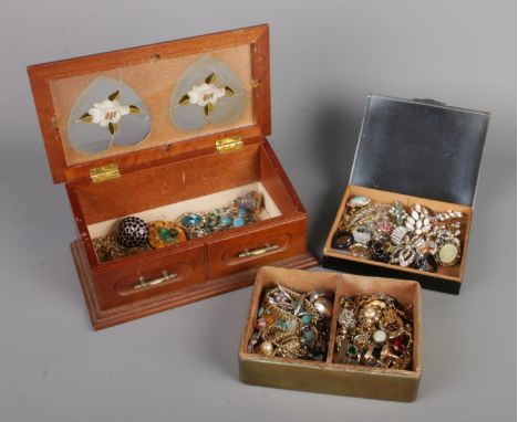 Three jewellery boxes, including a brass "State Express Cigarettes" box, all filled with costume jewellery such as brooches, 