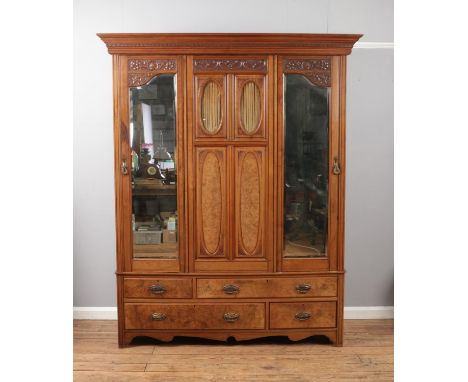 A Victorian walnut double wardrobe featuring mirrored doors  above four drawers.