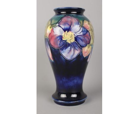 A Walter Moorcroft (1953-78) blue ground baluster shaped vase, in the clematis pattern. Bearing sticker to the base 'By Appoi