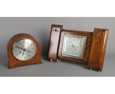 An oak cased Anvil mantel clock, together with an oak wall mounted 'English Made' barometer with two hooks.