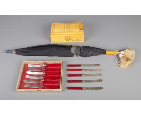 A quantity of Bakelite items to include British Buttner Pipe Co. Art Deco box, Bakelite handled parasol and set of tea knives