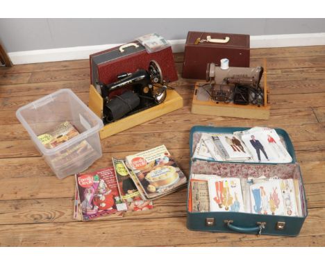 Two vintage Singer sewing machines along with a box of Family Circle magazine and suitcase of sewing patterns including McCal