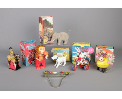 A collection of vintage clockwork and articulating toys and figures. To include clockwork musical monkey, bunny tricycle, ele