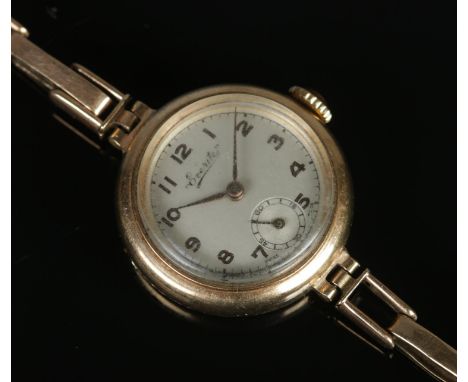 A ladies 9ct gold Everite manual wind cocktail watch, on 9ct gold expanding strap. With 15 Jewels Swiss movement; the silvere