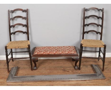 A large polished metal fireplace fender, together with a pair of ladder back chairs with rush seats and a stool.  Size: Fende