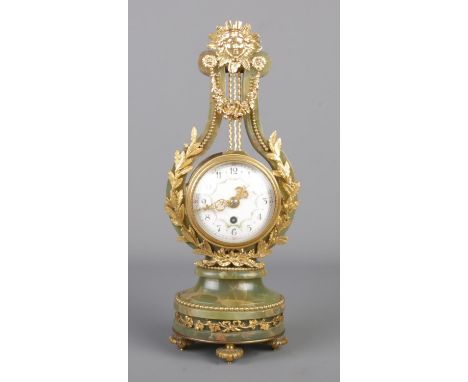 A late 19th century French lyre mantel clock with mechanical escapement, featuring a green onyx case mounted with gilt bronze
