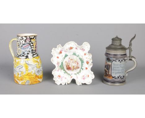 A German Hauber &amp; Reuther lidded beer stein, together with a porcelain pin dish with transfer painted Haufmann scene depi