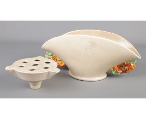 A Clarice Cliff Wilkinson pottery fan shaped vase, 777, along with a Clarice Cliff Newport pottery flower frog.