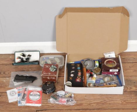 A box of fly fishing equipment, including unused lines, casts, priests, competition badges, flies and reels (Hardy Bros 3 3/8
