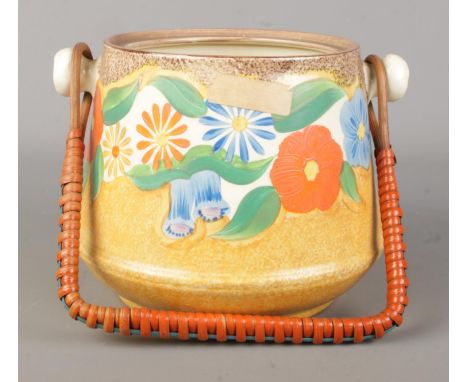 A Clarice Cliff Newport Pottery Bizarre biscuit barrel decorated in the Canterbury Bells design. Shape 336.  Missing lid.