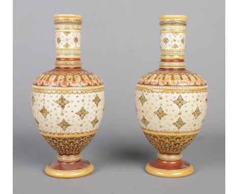 A pair of Mettlach, Villeroy and Boch stoneware baluster vases, raised on pedestal bases. Decorated in burnt oranges and oliv