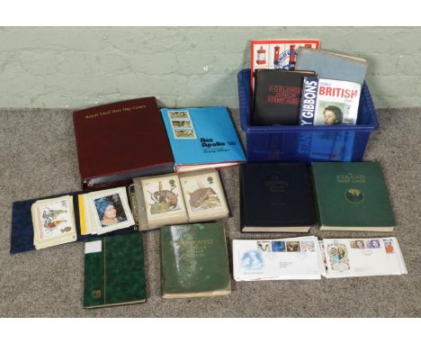 A box of vintage philatelic items, including albums of PHQ cards and First Day Covers, several world stamp albums and stamp c