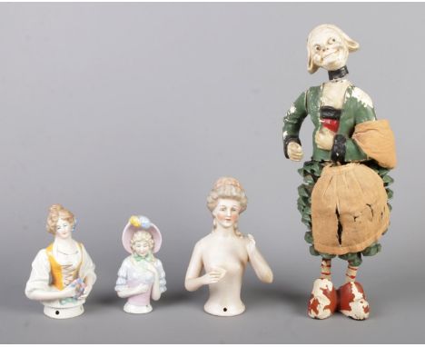 An antique French Becassine figure doll with a pine-cone skirt, jointed right arm and wooden stick legs (H27cm), together wit
