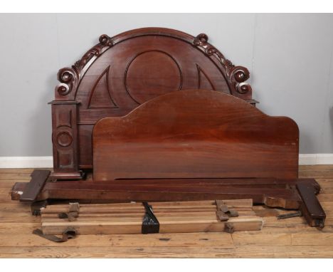 A Victorian mahogany double bed with carved foot and headboard.