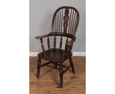 An ash/elm Windsor arm chair featuring bobbin turned arm supports.