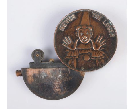 A novelty circular casino jeton lighter in copper tone, embossed with clown "Never the Loser" on one side, nude woman "Always