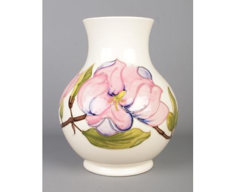 A large cream ground Moorcroft (1950-86) vase in the Hibiscus pattern, with flared rim. Stamped to the base, bearing WM initi