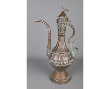 An eastern copper ewer featuring bird finial and engraved decoration. Approx. height 53cm.