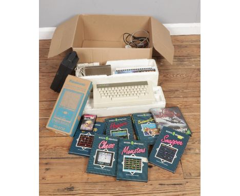 A boxed Acorn Electron vintage home computer system and games with a Panasonic portable cassette tape recorder
