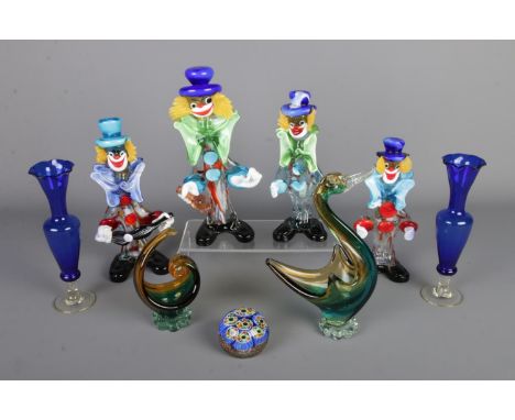 A collection of coloured art glass to include four Murano style clowns, two baskets, paperweight and pair of blue glass vases
